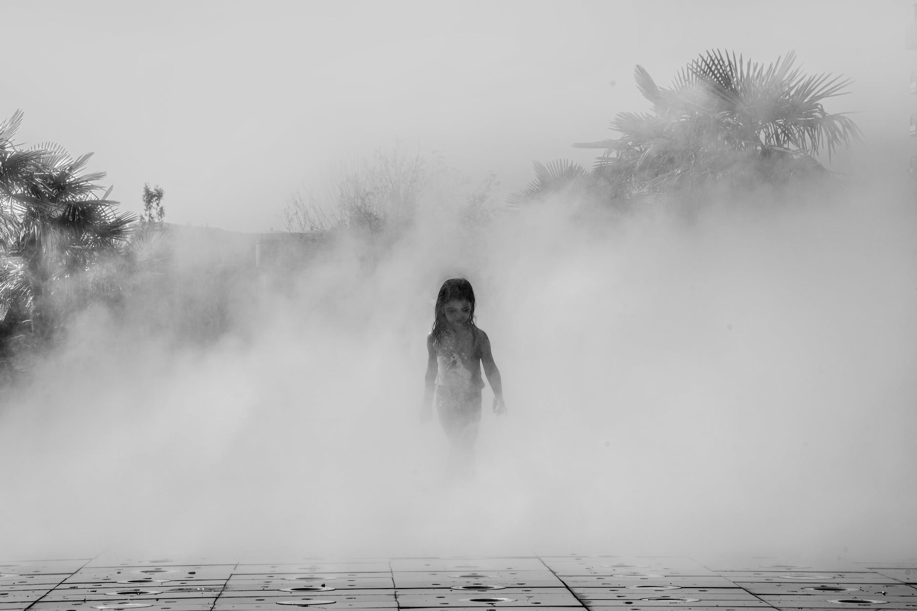 girl walking in steam in black and white