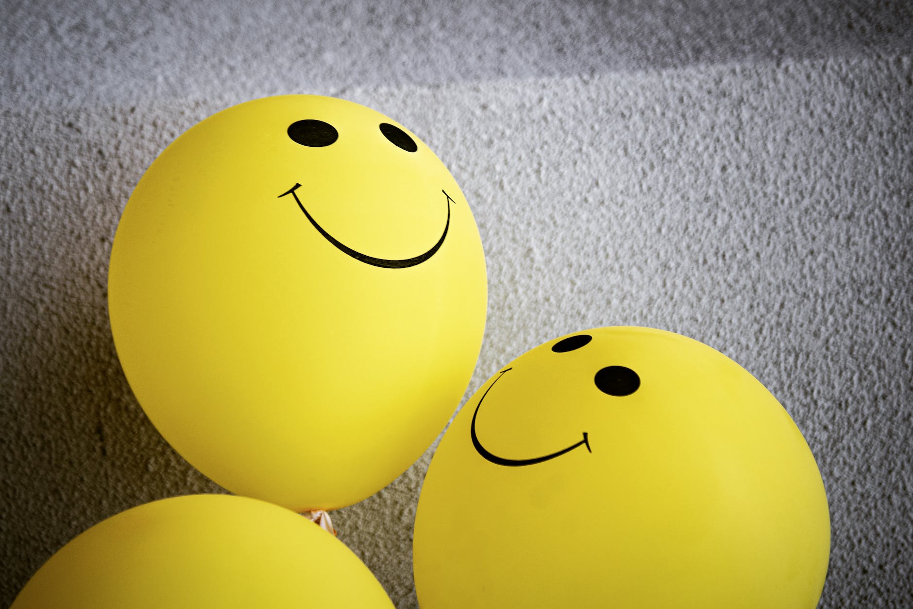 yellow smiley emoji on gray surface